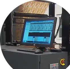 Computer with an industrial printer in the background