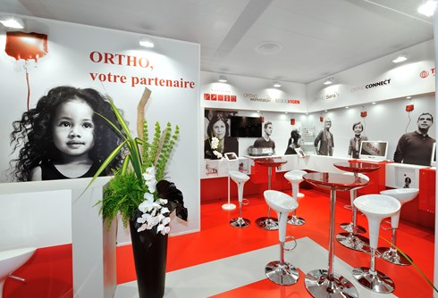 Ateliers Cassandre booth display, featuring large images of people