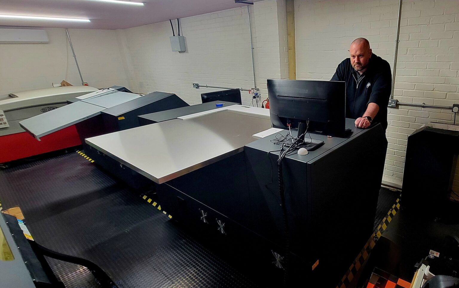 Image of a man looking at a computer monitor, using a CDI Spark imager.